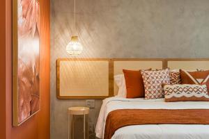 a bedroom with a bed with orange and white pillows at TW Cyclinn Vila Olimpia in São Paulo