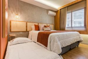 a bedroom with two beds and a window at TW Cyclinn Vila Olimpia in São Paulo