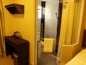 Postel nebo postele na pokoji v ubytování Hotel Vevo Puchong Malaysia