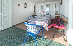 a table and chairs in a room with a table and a table and chairs at Lovely Apartment In Barbariga With Wifi in Barbariga