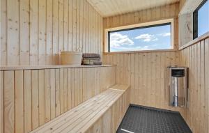 a wooden sauna with a bench and a window at Beautiful Home In Ebeltoft in Ebeltoft +27 photos