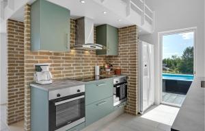 a kitchen with a sink and a stove at Beautiful Home In Ebeltoft in Ebeltoft