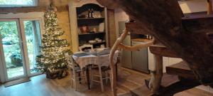 a kitchen with a christmas tree and a table with chairs at Gîte Ô Nature in Varen