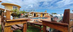 a wooden table and benches in front of a house at Espuma de Sal in Mazo