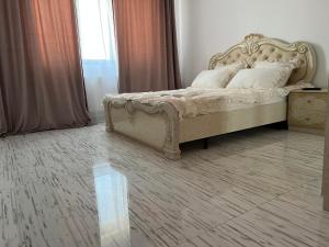 a bedroom with a large bed in a room at Dream Studios 2 in Bucharest