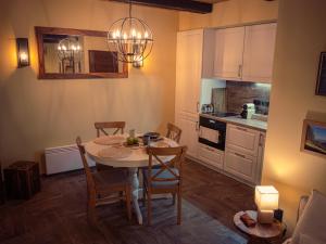 a kitchen with a table and chairs in a room at Spirit of the Earth Cottage Dobogókő in Pilisszentkereszt +21 photos