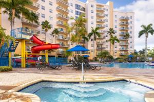 a pool at a resort with a slide at Club Wyndham Palm-Aire in Pompano Beach