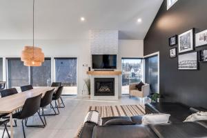 a living room with a dining table and a fireplace at White House 843 - 3 chambres - 8 personnes in Saint-Férréol-les-Neiges