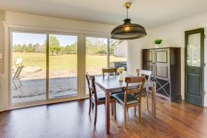 a dining room with a table and chairs and a large window at Fire Pit and Grill Tyler Home on 5 Acres! in Tyler