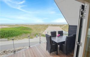 a table and chairs on a balcony with a view of a road at Two-Bedroom Apartment In Thisted in Thisted