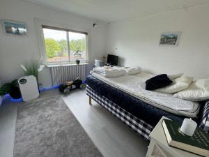 a bedroom with two beds and a window at Villa Solborg in Mölnlycke +59 photos