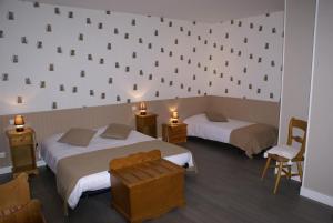 a hotel room with two beds and a wall with squares at Logis Hotel Restaurant Le Vedaquais in Vaas