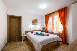 a bedroom with a bed and a window at Villa Nikol Apartment #1 in Raduil