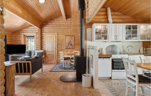 a kitchen and living room with a stove at Holiday Home Blokhus 59 in Blokhus