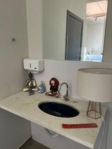 a bathroom counter with a sink and a mirror at Instituto Aterra OUT in Porto Alegre