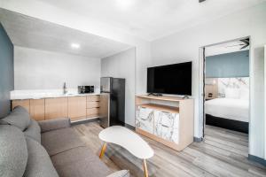 a living room with a couch and a bed at Pacific Inn and Suites in San Pedro
