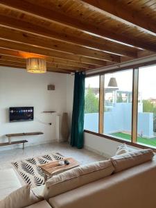 a living room with a couch and a large window at A sunny Bohemian chalet in Dahab in Dahab
