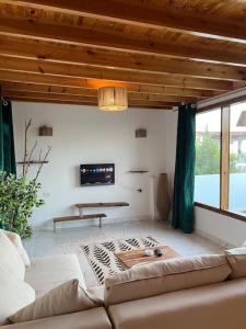 a living room with a couch and a tv at A sunny Bohemian chalet in Dahab in Dahab +9 photos