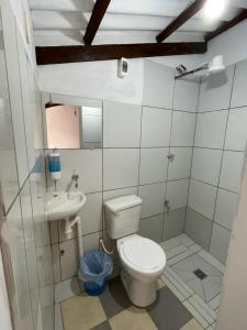 a bathroom with a toilet and a sink at Casa Agua Dulce in Samaipata