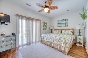 a bedroom with a bed and a ceiling fan at Ocean View Condo - Pool - Side Ocean View Decks on Each Floor in Surf City