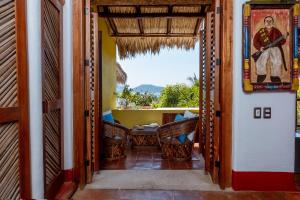an open door to a room with a table and chairs at Ensueño de Fuga in Zihuatanejo