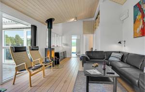 a living room with a couch and a table at Cozy Home In Jerup With Sauna in Jerup