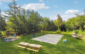 a park with two picnic tables and a playground at 5 Bedroom Amazing Home In Herning in Herning +29 photos