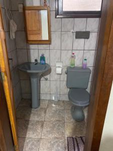 a small bathroom with a toilet and a sink at LARA'S HOUSE in São Sebastião +40 photos
