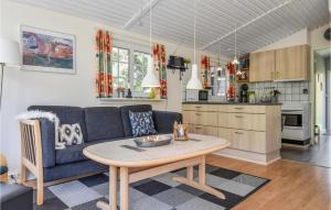 a living room with a couch and a table at Two-Bedroom Holiday Home In Ringkobing in Ringkøbing