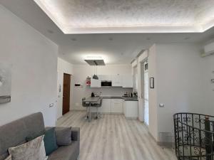 a living room with a couch and a kitchen at B&B Stella in Somma Lombardo