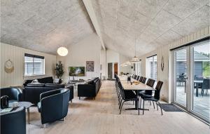 a living room with a table and chairs at Nice Home In Spøttrup With Sauna in Spottrup