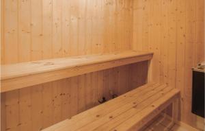 a wooden sauna with a wooden shelf in it at Holiday Home Hvedemarken Sjølund Iii in Hejls