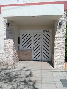 a garage with a white door and a brick wall at Mar de Ana in San Bernardo +7 photos