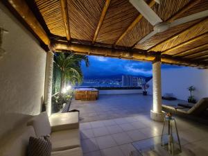 an outdoor patio with a view of the city at Penthouse en Las Brisas Acapulco in Acapulco