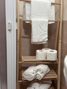 a towel rack in a bathroom with towels at La Petite Maison de Grand-Mére Assunta in Nola +125 photos