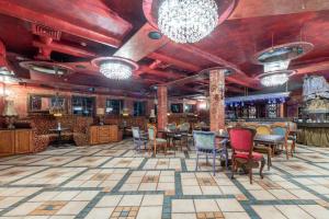 un bar con sedie e tavoli in una stanza di Vilos NEMUNO SLĖNIS Liuxas a Birštonas