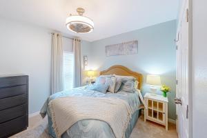 a bedroom with a bed with a blue comforter at Sunscape Oasis in Clermont