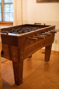 a large wooden table sitting on top of a wooden floor at Cozy Cabin Smoky Mountains - Hot tub, pool, & golf in Townsend