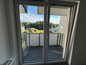 a sliding glass door with a view of a balcony at Apartament 8 in Tychy