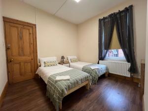 una camera da letto con due letti e una finestra di Gr8 Hostel at The Mount a Belfast