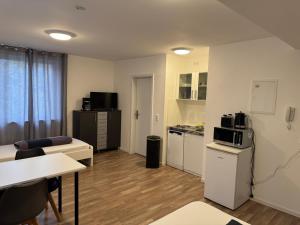 a small apartment with a kitchen and a living room at Gästehaus by Becker in Eppelheim
