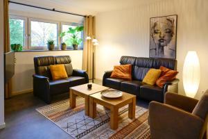 a living room with two couches and a coffee table at Appartement Siebengewald in Siebengewald +19 photos