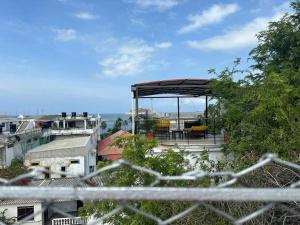 a view of a building with a pavilion on the roof at Apartamento Bahía de Santa marta in Santa Marta