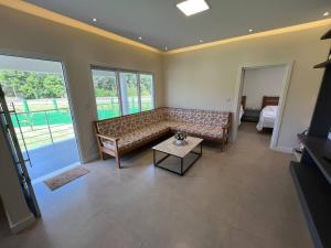 a living room with a couch and a table at Casa Sítio Caminhos Da Serra in Feliz +17 photos