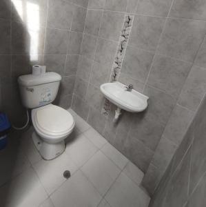 a bathroom with a toilet and a sink at Departamento Yavari in Iquitos