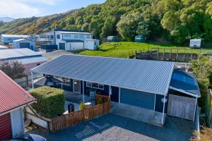 an aerial view of a house with a blue roof at Cosy Private Home in South Bay in Kaikoura