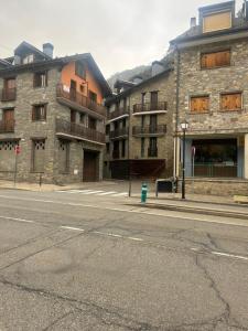 an empty street in front of two buildings at Mirador al Pirineo in Escarrilla