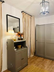a room with a mirror and a cabinet and a door at Casa Cara in Târgovişte