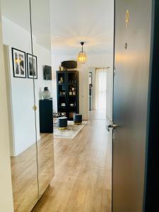 a hallway with a glass door and a room with wood floors at Casa Cara in Târgovişte