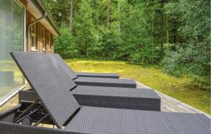 a group of chairs sitting on a deck at Holiday Home Skovsgårdsvej in Hals